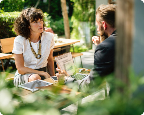 Lady and man having a discussion around a picnic table