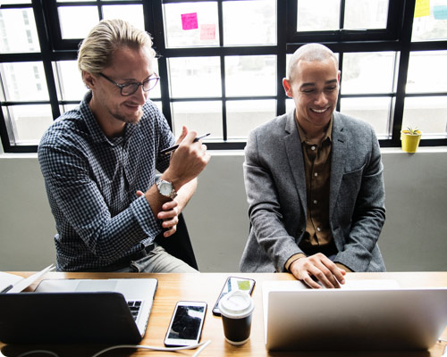 Two men sitting around a laptop