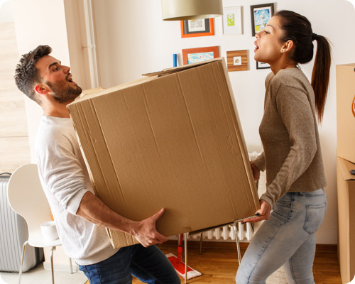 Two people carrying a large parcel