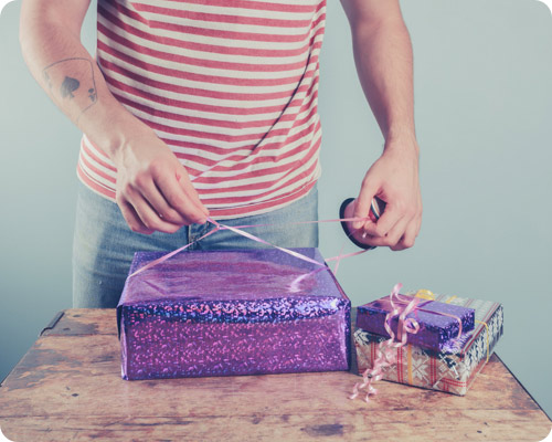 Man wrapping a present