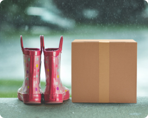 Wellies in the rain with a parcel