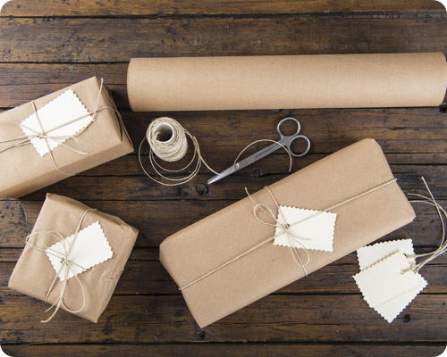 Scissors and brown paper with parcels